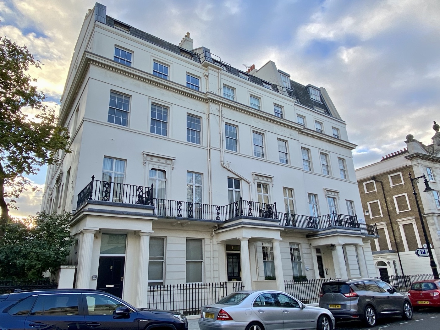 A white stucco apartment building in Belgravia