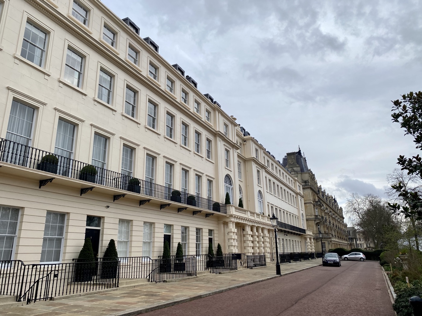 A stucco terrace of tall London town houses on a clear morning